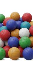 A pile of colorful volleyball balls on a white background photo
