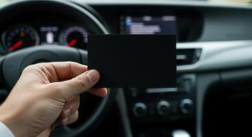 A person holding a blank card in the driver's seat photo