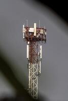 A tower with multiple antennas on top photo
