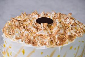 Toasted Lemon Meringue Layer Cake featuring moist cake layers with a tangy lemon filling isolated on grey background top view of stunning dessert photo