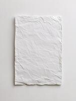 A sophisticated paper mockup presents a blank textured canvas on a pristine background, perfect for showcasing branding or artwork with ease. photo