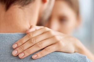 Close-up of a gentle touch between a couple, showcasing intimacy and connection, with soft lighting creating a warm and caring atmosphere of affection and support photo