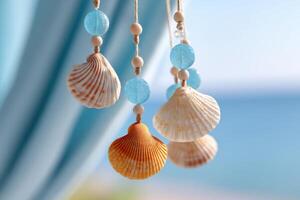 Decorative seashells hanging on a string with blue beads, creating a coastal ambiance, with a blurred ocean background and soft natural light enhancing the serene atmosphere photo