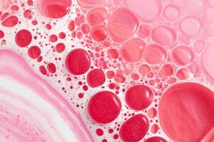 Macro shot of bubble texture forming a pink and vermillion abstract background photo