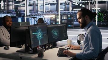 Overworked technician in data center managing server infrastructure for AI inference tasks. Fatigued employee using PC to maintain supercomputers running artificial intelligence tech, camera A video