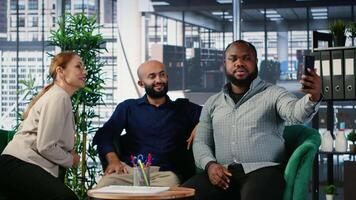 Diverse business leaders finishing their meeting and taking photos, ensuring their presence on social media platform and marking the beginning of a fruitful corporate partnership. Camera B. video