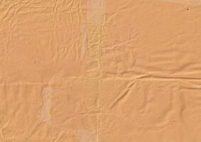 Brown crumpled paper texture background for overlay. Old and used cardboard backdrop template. photo