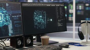 Close up of monitors in data center office overseeing hardware supporting AI training workflow. PC screens tracking servers processing machine learning datasets, handheld camera shot video