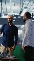 Vertical Multicultural group of CEOs welcoming each other in a negotiations meeting, discussing latest details for a new successful partnership between their international corporations. Networking. Camera A. video