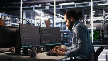 Engineer in server hub dealing with unexpected system error alert, showing signs of fatigue and irritation. Data center IT professional attempt multiple fixes after repeated failure warnings, camera A video