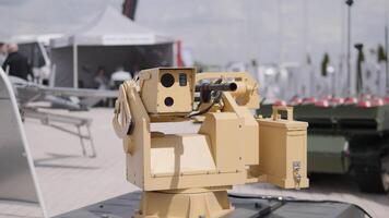 Explore an advanced robotic weapon system displayed at a defense expo, showcasing modern military technology. video