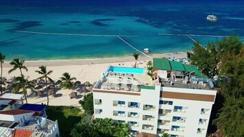A hotel with a rooftop pool on the oceanfront. Bright sunny day in Punta Cana video