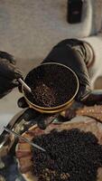 Chef holding open tin of black caviar over scallop shell video