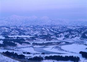 A view of the mountains and river from a high point photo