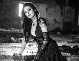 beautiful young goth woman in abandoned factory in bw photo