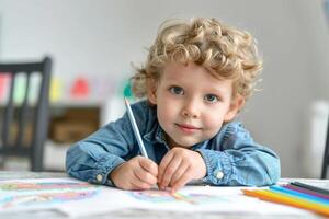 Young child drawing with colored pencils at a table indoors photo
