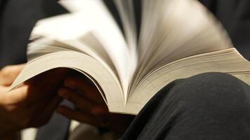 Reading a book in a cozy setting with warm lighting video