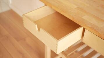 Exploring an empty wooden drawer in a kitchen setting video