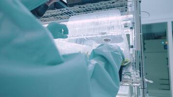 Scientist workers open cultivating container for plants quality check, growing small plant inside indoor humidity control room, science laboratory work research, cannabis sprouting process, lab data video