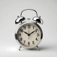 A gleaming chrome alarm clock on a white surface emphasizes punctuality and routine. photo