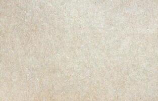 Eco-friendly recycled paper texture with visible fibers and neutral beige tone, ideal for backgrounds photo