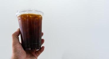 Iced black coffee on hand with copy space for text. photo