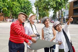 Group of senior tourist are looking at city maps to find tourist attractions in Chiang mai city. photo