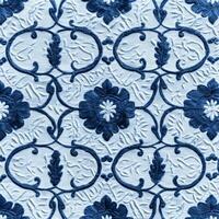 A blue and white patterned wallpaper with flowers photo