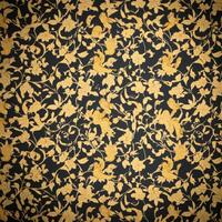 Golden floral pattern on black background photo