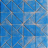 A blue tile with a geometric pattern on it photo