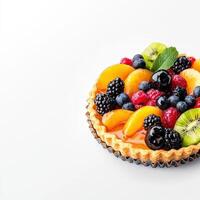 Fresh fruit tart with fresh berries and mint on white background photo