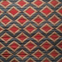 A red and gray quilt with a diamond pattern photo