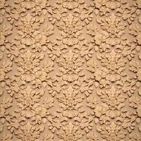 An old beige wall with a floral pattern photo