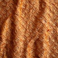 An orange fabric with a pattern of scales photo