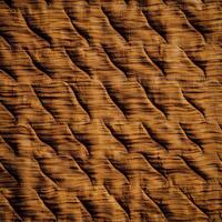 A brown quilt with a pattern of wavy lines photo