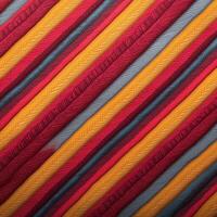 A colorful striped fabric with a pattern photo