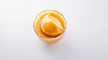 A glass of orange juice on a white surface photo