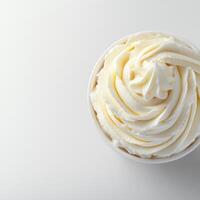 A cup of whipped cream on a white surface photo