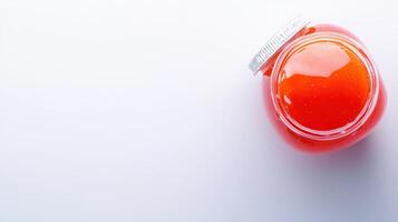 A red liquid in a jar on a white surface photo