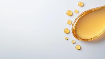 A drop of oil is shown on a white background photo