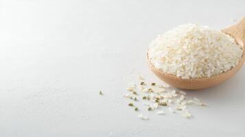 White rice in a wooden spoon on a white background photo