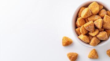 A bowl of sugar coated pretzels on a white surface photo