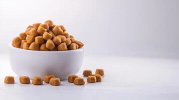 A bowl full of peanut butter cups on a white table photo