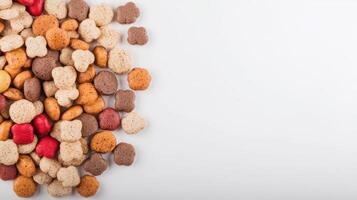 A pile of different colored dog food on a white background photo