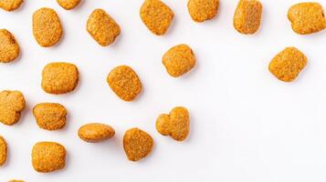 A bunch of orange dog food on a white surface photo