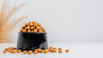A black cup filled with marshmallows on a white table photo