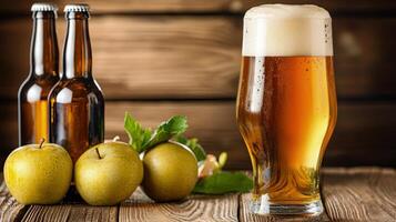 A glass of beer and two apples on a wooden table photo