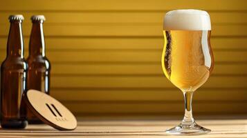 A glass of beer sitting on a table next to two bottles photo