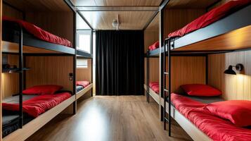 A bunk bed with red pillows and black curtains photo
