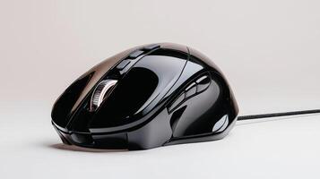 A black computer mouse on a white surface photo